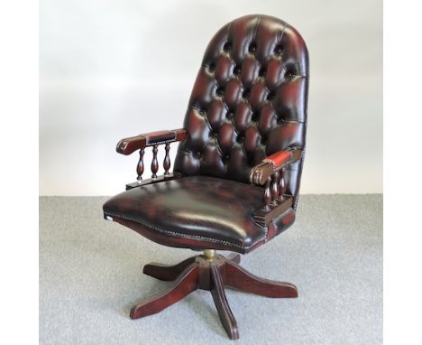 A red leather upholstered button back desk chair 