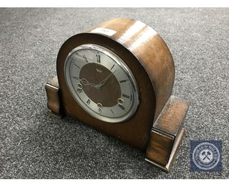 An oak cased Smiths Enfield mantel clock with pendulum and key