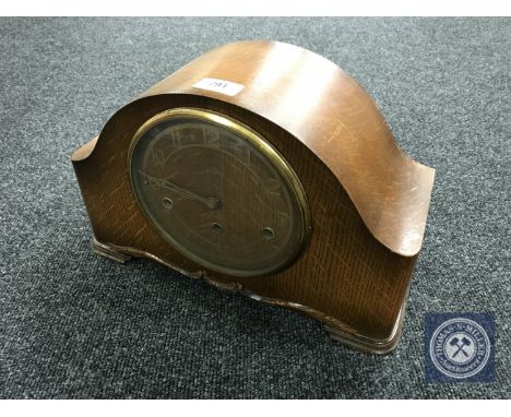 An oak cased Smiths Enfield mantel clock with pendulum and key