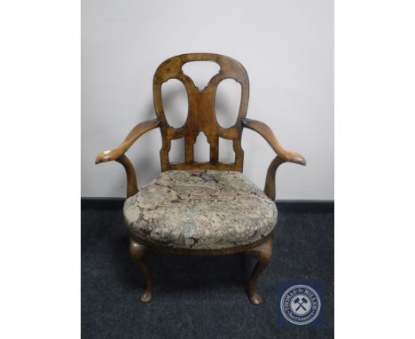 A Victorian walnut tapestry upholstered armchair on cabriole legs 
