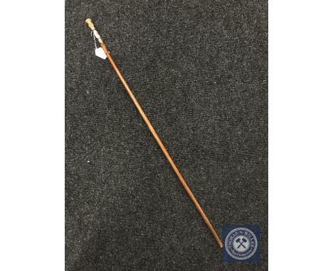 A swagger stick with 18ct gold plated and enamel mount