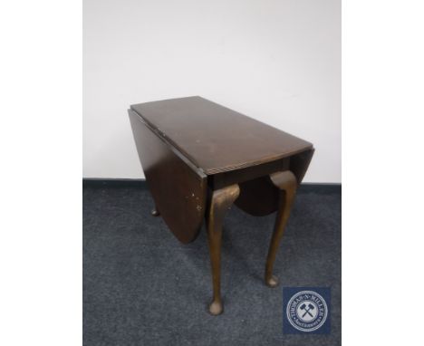 A mahogany gate leg table on club feet 