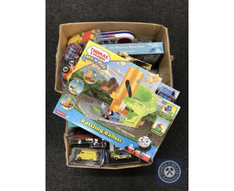 Two boxes of assorted toys including die cast vehicles, Thomas the Tank Engine rails, postcards, jigsaw etc 