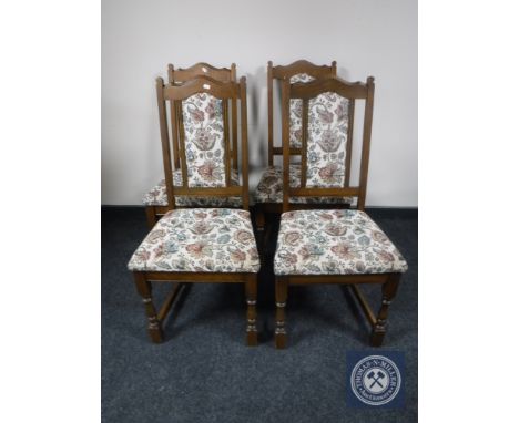 A set of four oak Old Charm tapestry upholstered dining chairs