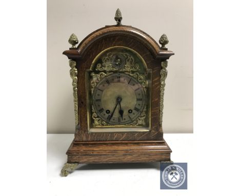 A late Victorian oak eight day bracket clock with brass dial and mounts