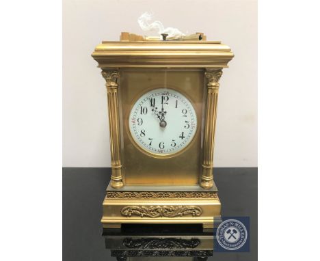 A 20th century brass cased striking and repeating carriage clock, with pillar supports and enamelled dial, platform escapemen