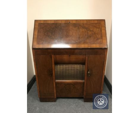 An early 20th century HMV radio turn table bureau, with integrated speaker and storage. 