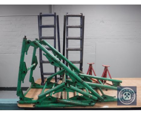 A pair of car axle stands and car ramps and a metal folding ladder 