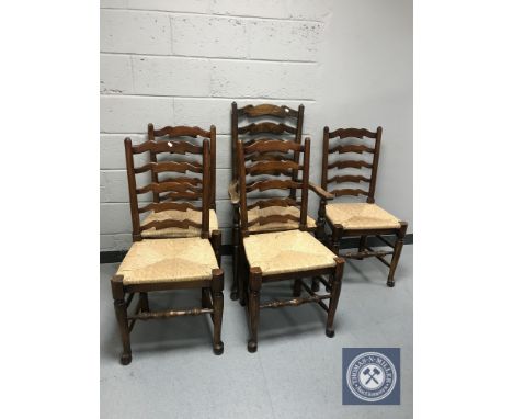 A set of five rush seated ladder backed kitchen chairs (one carver and four singles)