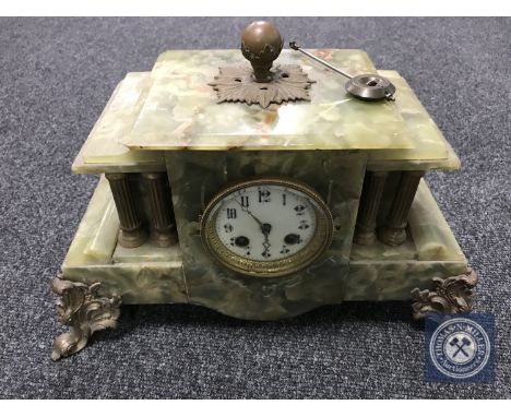 An onyx and brass mantel clock with enamelled dial