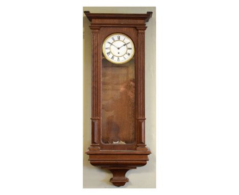 Oak cased Vienna style wall clock, the white enamel dial with Roman numerals   Condition: 