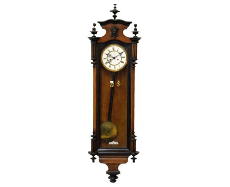 Late 19th Century walnut and ebonised cased Vienna wall clock, the white enamel dial with Roman numerals, twin weight movemen