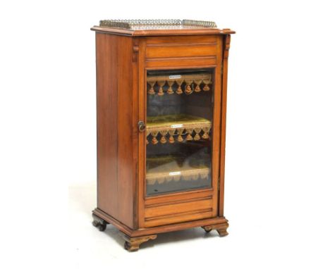 Edwardian stained walnut music cabinet with gilt metal gallery and serpentine front top over glazed door enclosing labelled p