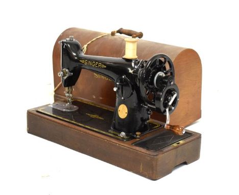 A cased Singer sewing machine, the case is faux crocodile skin