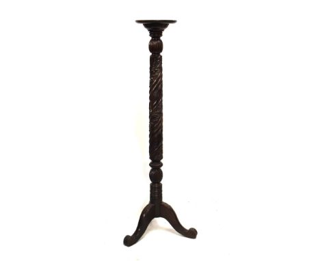 Carved mahogany torchère or lamp stand with dished circular top on spiral-carved stem and tripod support, 27cm diameter x 149