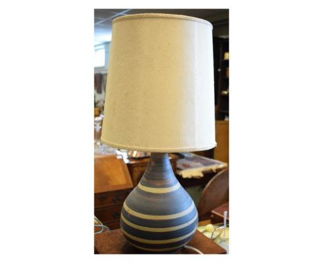 Pottery lamp base of bulbous form with banded decoration, 31cm high, together with a fabric shade, overall height 57cm   Cond