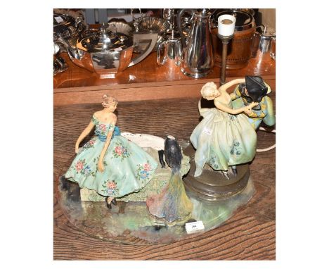 Early to mid 20th Century table mirror with bevelled oval plate, the painted plaster base modelled as a lady observing a peac