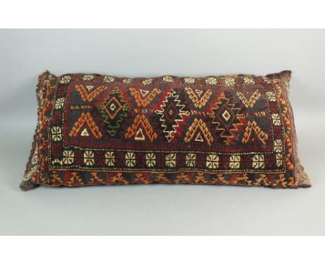 A large Afghan cushion or pillow with geometric lozenge design against an indigo and madder ground, 95cm wide