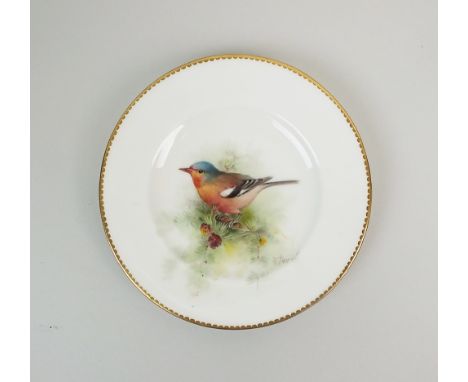 A Royal Worcester plate, date code for 1922, finely painted with a Chaffinch and signed W. Powell, within gilt tooth borders,