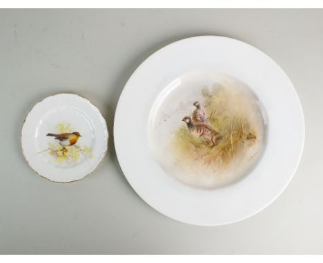 An English porcelain plate painted by James Stinton with red legged partridge and signed 'Jas Stinton' within a broad plain b