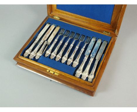 A Victorian cased part set of silver fruit knives and forks, Henry Wilkinson & Co, Sheffield 1856, each with decorative silve