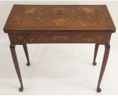 A DUTCH MARQUETRY OAK FOLD OVER CARD TABLE decorated with a basket of ribbon tied flowers, cornucopia and scrolling foliage, 