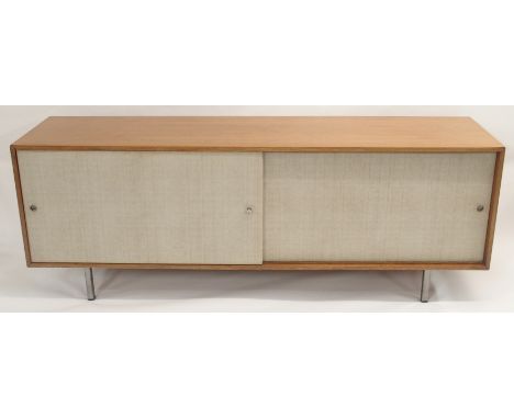 A MID CENTURY TEAK SIDEBOARD POSSIBLY BY FLORENCE KNOLL, on chrome legs with two sliding doors and four internal sliding draw