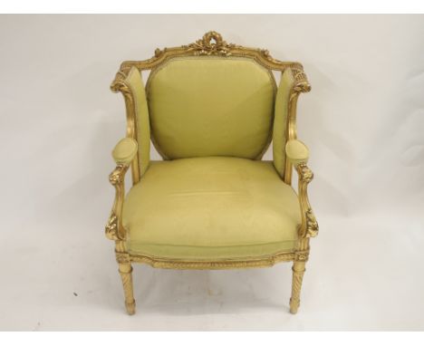 A LOUIS XV STYLE GILTWOOD ARMCHAIR the frame carved with laurel wreath, acanthus and stiff leaves, silk upholstered, 83cm hig