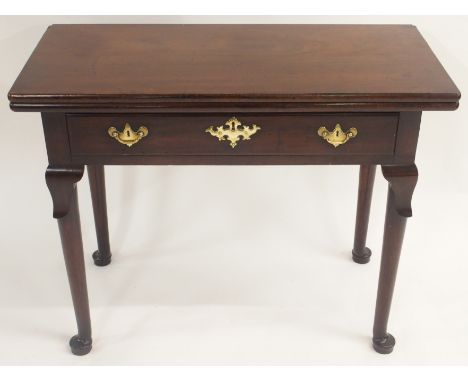 A GEORGE III MAHOGANY FOLD OVER TEA TABLE the hinged top above a drawer on leaf capped tapering legs and pad feet, 73cm high,