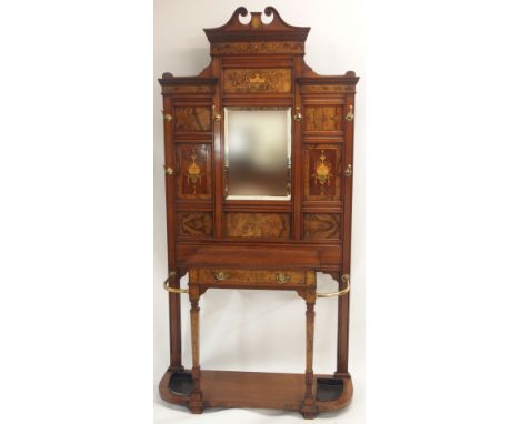 A VICTORIAN WALNUT HALL STAND with mirror back surrounded by inlaid urn panels, fitted with six brass hooks above a drawer an