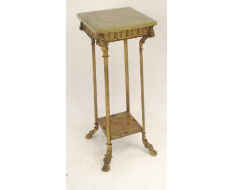 A GILT METAL AND GREEN ONYX PEDESTAL cast with acanthus leaf and on square legs joined by a shelf and on foliate feet, 81cm h