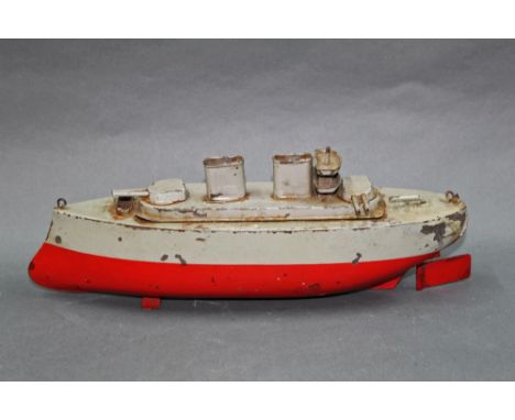 A 1920's tin plate and clock work Sutcliffe war ship, in grey and red, measuring 31 cm long. 
