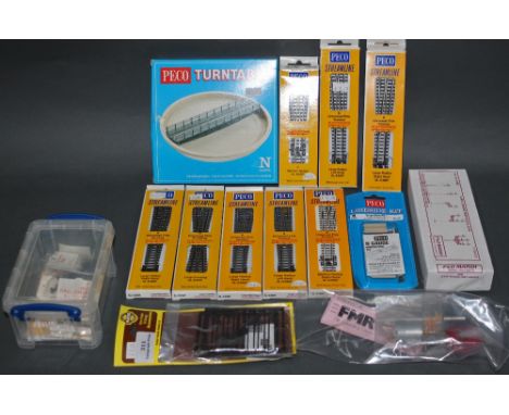 A group of N gauge model railway accessories, including a Peco turn table, track pins, a P &amp; D Marsh square post signal s