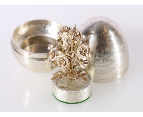 Elizabeth II silver 'surprise' egg containing floral posy (possibly roses) in the manner of Stuart Devlin, with makers marks 