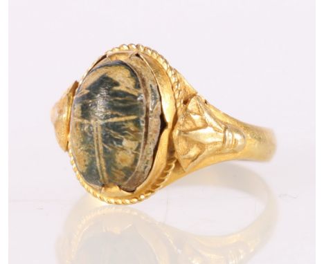Unhallmarked yellow metal ring set with carved horn? cabochon with primitive whorl and beetle designs, size P, 3.6g.CONDITION