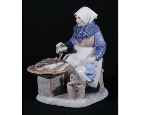 Royal Copenhagen figure of a women fish seller with eels, flat fish and fish, blue mark to base, number 465, 22cm tall.CONDIT