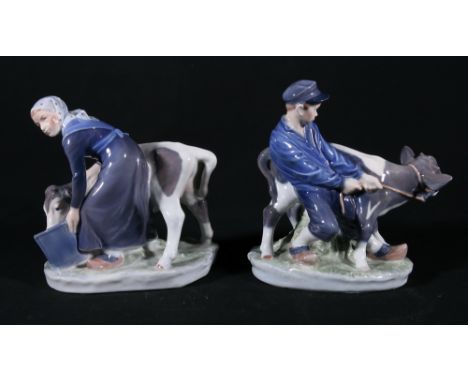 Two Royal Copenhagen figures of boy and girl with cow, numbers 074 and 075 to the bases, 18cm and 16cm tall.CONDITION REPORT: