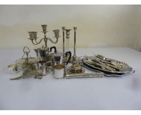 A quantity of silver plate to include a teaset, a candelabrum, condiments and flatware