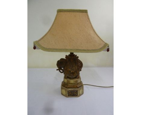 A carved plaster elephant table lamp on octagonal base with shade