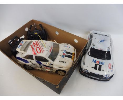 A Thunder Tiger Ford Escort Cosworth 1/10 scale nitro touring remote controlled car and a Kyosho Ford Escort Cosworth 1/10 sc