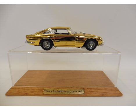 A Danbury Mint James Bond 007 24ct gold plated DB5 handcrafted from over 300 individual parts, the 1:24 scale diecast model f