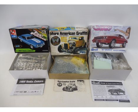 Three boxed scale model kits including a 1969 Yenko Camaro from 'The Fast and the Furious' film and the 'Yellow Deuce Coupe' 