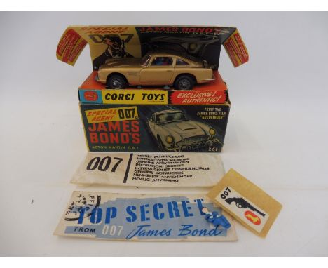 A 1965 Corgi 261 James Bond 007 Aston Martin DB5 in its original inner and outer box with opened instruction envelope, secret