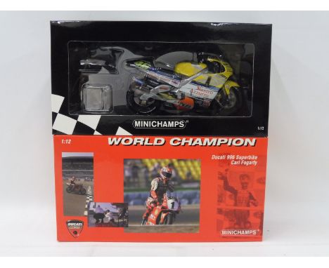 Two boxed Minichamps scale models of racing mototrcycles. 