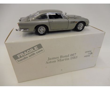 A Danbury Mint James Bond 007 Silver DB5 handcrafted from over 300 individual parts, this 1:24 scale model was created to rep