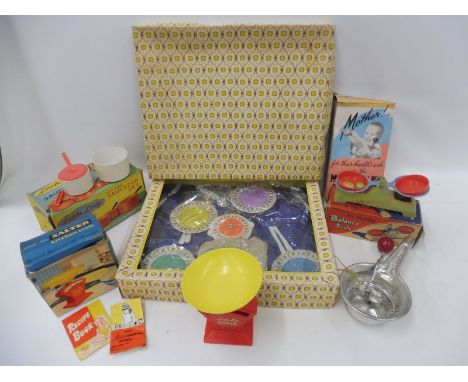 A group of early boxed children's toys including a Little Lady Playtime Saucepan Set by Bell, a Peter Pan all plastic balance