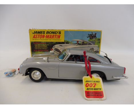 A 1965 Gilbert James Bond 007 tinplate Aston Martin DB5 - a rare find in this condition. Produced in Japan, this excellent ex