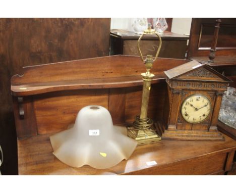 A brass Corinthian columned table lamp base with a large glass shade 