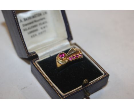 A yellow metal ring set with ruby coloured stones, stamped 10K