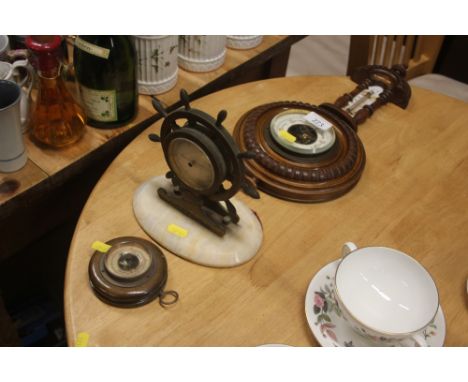 A late Victorian walnut cased barometer; and two other barometers, one in the form of a ships wheel